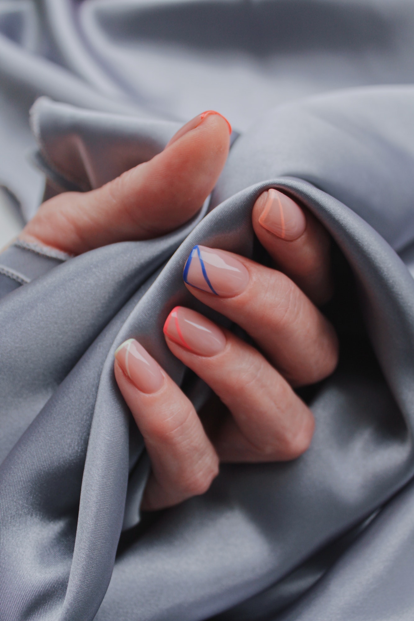 Manicure on a grey fabric textile